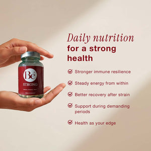 Be Strong supplement bottle held in hands with daily nutrition benefits for immune resilience and energy